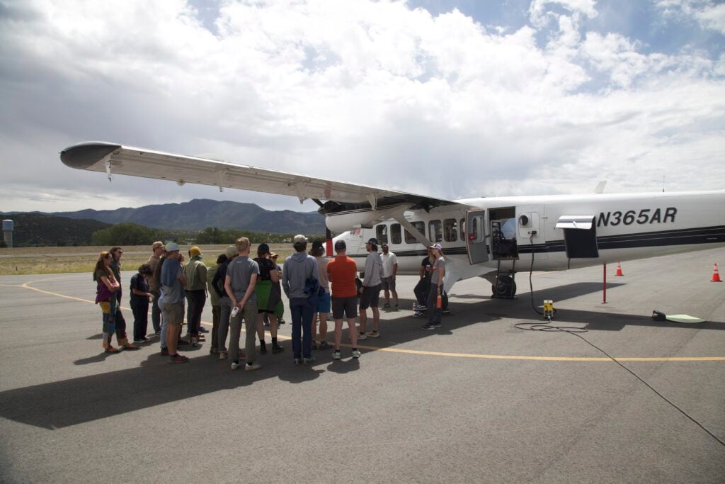 Students gather outside the plane.