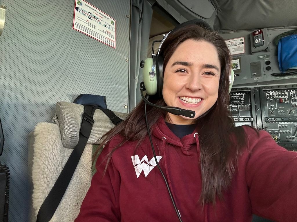 Autumn Moya takes a selfie in a Western sweatshirt with a headset on a ship.