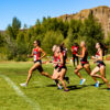 the womens cross country race begins as the women take off with the palisades behind them