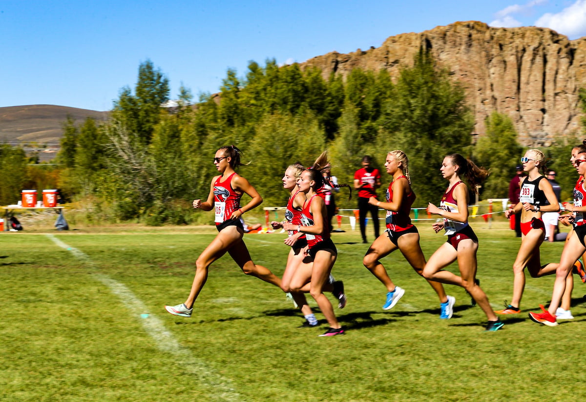 the womens cross country race begins as the women take off with the palisades behind them