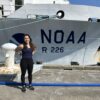 Autumn Moya poses next to the NOAA ship.