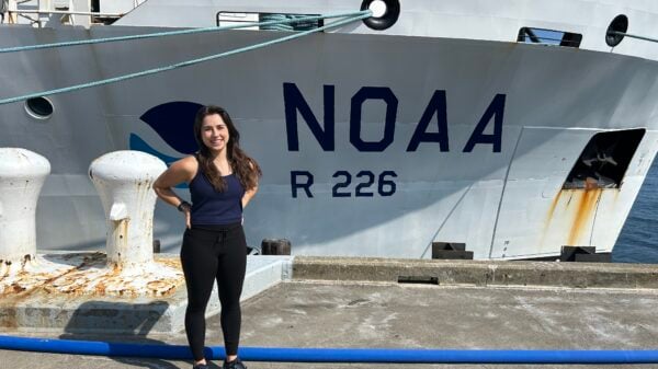 Autumn Moya poses next to the NOAA ship.