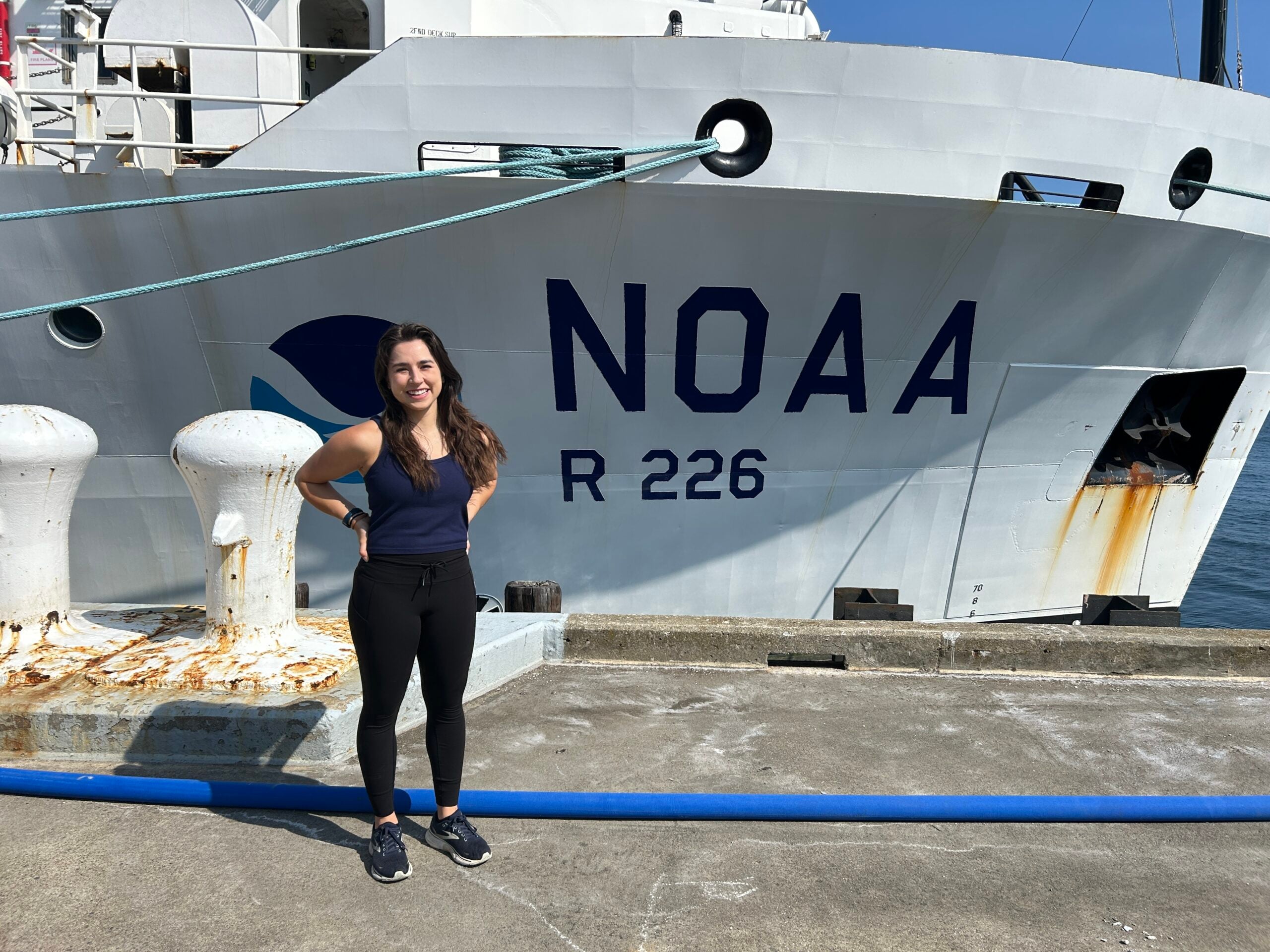 Autumn Moya poses next to the NOAA ship.