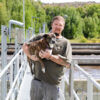 Don Getz, Wastewater Superintendent, holds his dog for a photo at the treatment plant.